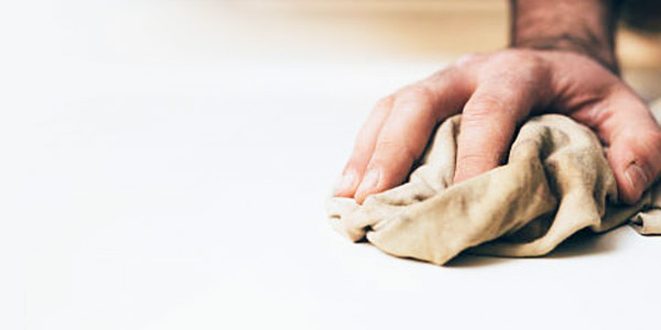 An image of someone wiping a surface with a wiping rag